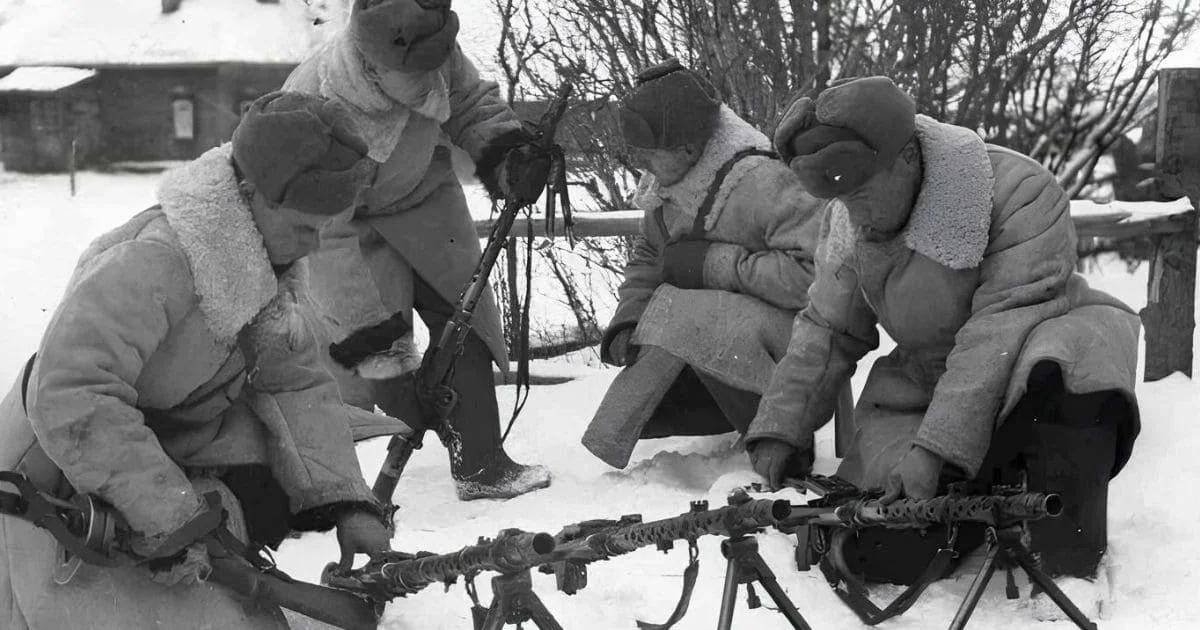 WW2 Soviet winter soldiers in warc coats uniforms with ushankas operating machine gun