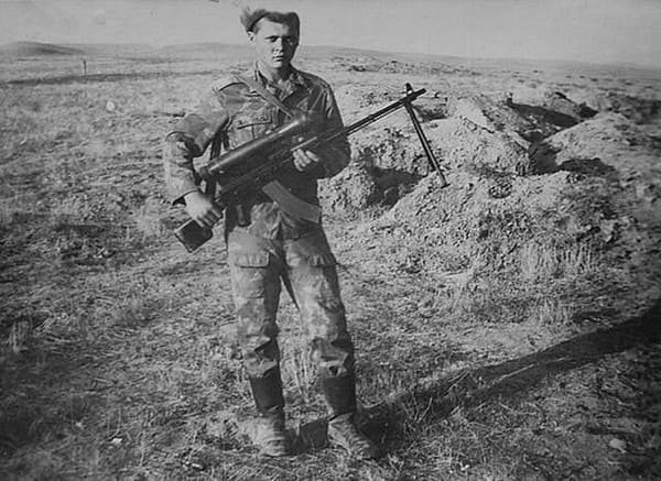 Soviet soldier wearing early camouflage uniform during field training, Cold War era