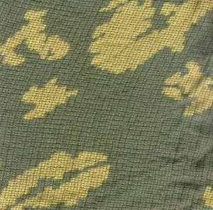 Close-up texture of Soviet KZS mesh fabric showing camouflage pattern and loose weave