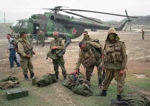 Soviet special forces wearing gorka suits in Afghanistan near military helicopter