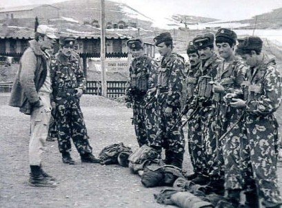 Soviet Spetsnaz soldiers during a combat readiness inspection in Afghanistan, wearing camouflage uniforms, historical black and white photograph