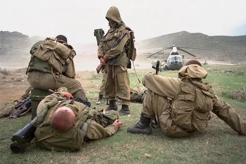 Soviet soldiers resting in gorka uniforms after helicopter landing in Afghanistan