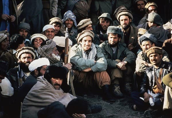 Ahmad Shah Massoud with mujahideen fighters wearing traditional pakol caps in Afghanistan during the 1980s war