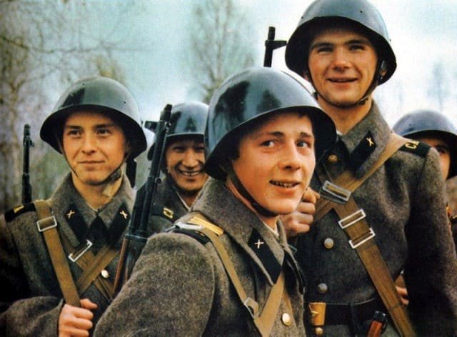 Cold War Soviet Army soldiers wearing winter general service uniform with wool greatcoats and steel helmets