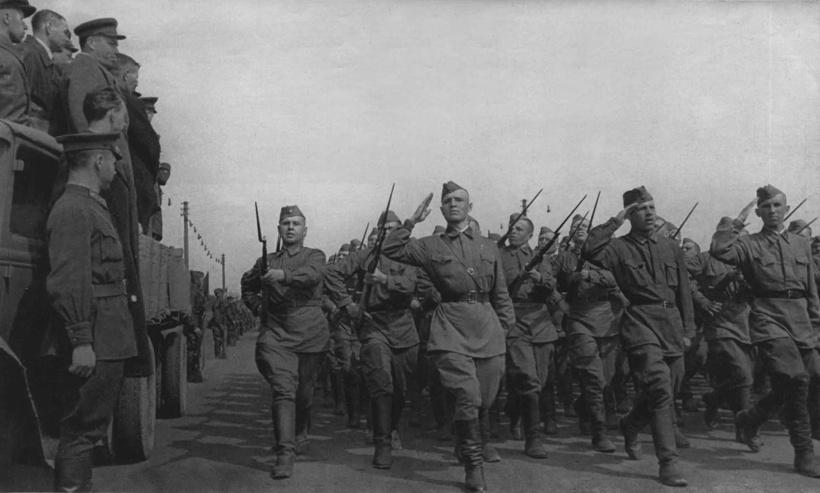Red Army soldiers marching to the front before 1943 wearing early WW2 Soviet military uniforms