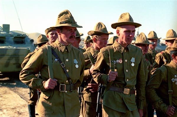 Soviet soldiers wearing early Afghanka uniform with wide-brim panama hats in Afghanistan, early 1980s