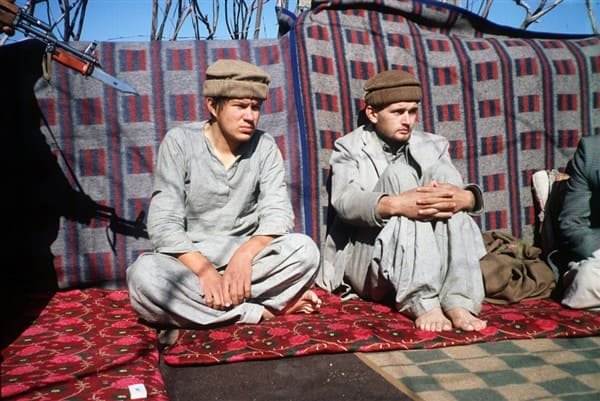Captured Soviet soldiers dressed in traditional Afghan clothing after being taken prisoner during the Soviet–Afghan War