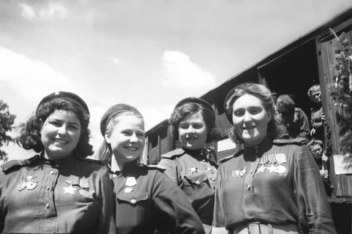 Group of Soviet women snipers wearing berets with a metal Red Army star, early World War II uniform, 1941