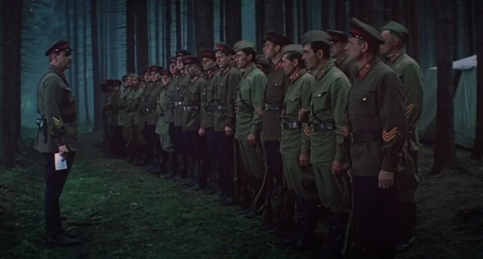 Soviet WWII officers formation showing collar tabs, sleeve insignia, pilotka caps, peaked caps, black leather belts and pistol holsters