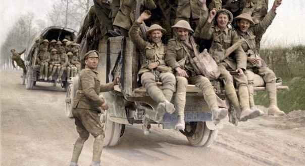 British soldiers wearing puttees and khaki uniforms riding military trucks during World War 1