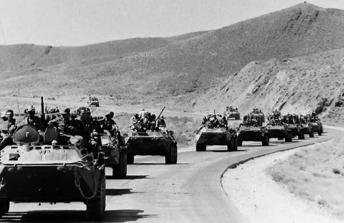Soviet troops and BTR armored vehicles moving through Afghanistan during the Soviet-Afghan War