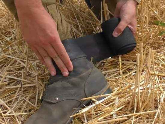 Rolling and preparing military puttees before wrapping them around army boots