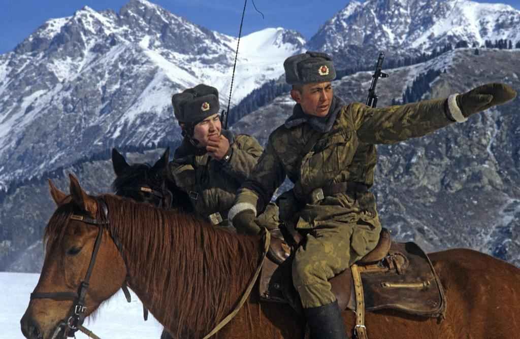 Soviet KGB Border Troops wearing ushanka hats on horse patrol in 1984