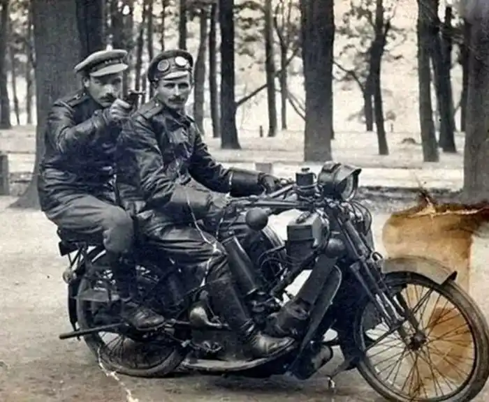 Two Soviet officers riding a motorcycle in leather clothing