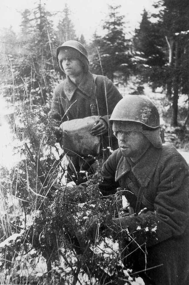 Soviet soldier wearing a helmet over an ushanka in World War II